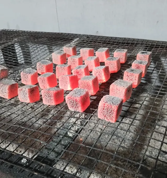Fornax coconut charcoal cube glowing during a burn test